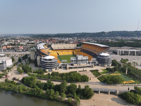Pittsburgh United States 26 July 2026 Aerial view of Acrisure Stadium with its distinctive yellow seating surrounding urban landscape and the nearby river.