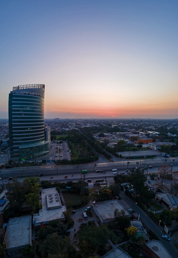 Aerial view of the Arfa Kareem Tower and the city skyline during sunset with rooftops and trees in Lahore Punjab Pakistan. Aerial view of the Arfa Kareem Tower and the city skyline during sunset with rooftops and trees in Lahore Punjab Pakistan.