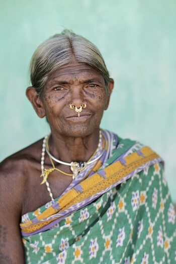 Odisha India 26 March 2026 View of an indigenous woman with weathered skin adorned with a traditional nose ring and draped in a vibrant green and yellow patterned sari. Odisha India 26 March 2026 View of an indigenous woman with weathered skin adorned with a traditional nose ring and draped in a vibrant green and yellow patterned sari.