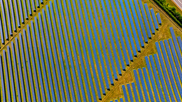 Aerial view of a large solar farm with rows of photovoltaic panels arranged in a field in Dorset England United Kingdom. Aerial view of a large solar farm with rows of photovoltaic panels arranged in a field in Dorset England United Kingdom.