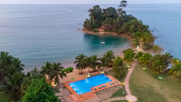 Axim Western Region Ghana 09 February 2023 Aerial view of Lou Moon Resort Eco Luxury featuring a swimming pool palm trees and a sandy beach along the coastline. Axim Western Region Ghana 09 February 2023 Aerial view of Lou Moon Resort Eco Luxury featuring a swimming pool palm trees and a sandy beach along the coastline.