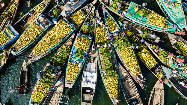 Rangamati Bangladesh 19 October 2022 Aerial view of traditional wooden boats laden with fresh coconuts and produce at a bustling floating market on the water.