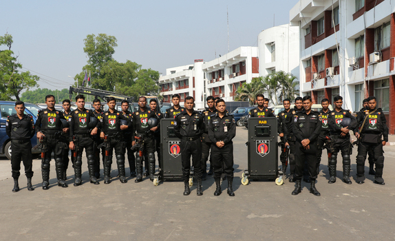 Dhaka Bangladesh 08 January 2017 View of RAB officers in black uniforms standing in formation with tactical gear and shields outside the RAB Headquarters building. Dhaka Bangladesh 08 January 2017 View of RAB officers in black uniforms standing in formation with tactical gear and shields outside the RAB Headquarters building.