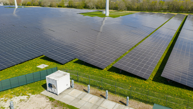 Aerial view of battery storage and mobile container charging at De Dijken Solar Park near Warmenhuizen supporting grid balance renewable energy and flexible power use. Aerial view of battery storage and mobile container charging at De Dijken Solar Park near Warmenhuizen supporting grid balance renewable energy and flexible power use.