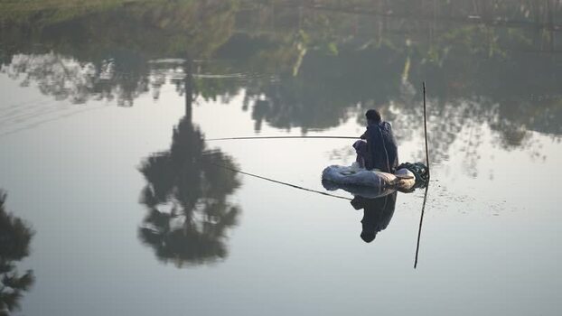 View of a fisherman on a raft in Bogura Bangladesh.