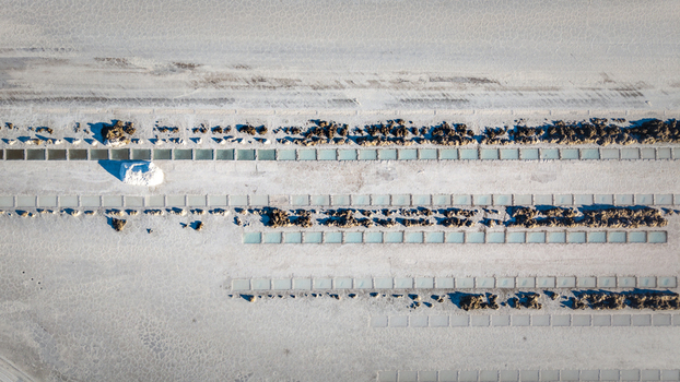 Aerial view of Salinas Grandes salt flats featuring geometric salt extraction pools with turquoise water and piles of harvested salt La Poma Department Salta Province Argentina. Aerial view of Salinas Grandes salt flats featuring geometric salt extraction pools with turquoise water and piles of harvested salt La Poma Department Salta Province Argentina.