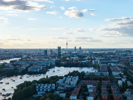 Aerial view of Rummelsburger Bucht with calm waters surrounding residential buildings and the distant Berlin skyline featuring the TV Tower under a soft sky in Berlin Berlin Germany. Aerial view of Rummelsburger Bucht with calm waters surrounding residential buildings and the distant Berlin skyline featuring the TV Tower under a soft sky in Berlin Berlin Germany.