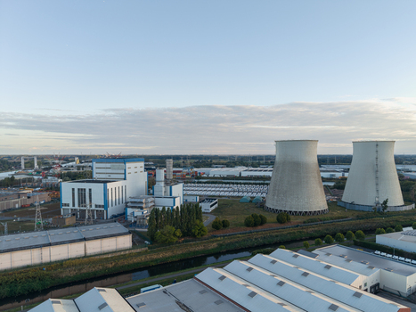 Aerial view of the former power plant site featuring two large cooling towers and a modern battery energy storage system installation in Vilvoorde Flanders Belgium. Aerial view of the former power plant site featuring two large cooling towers and a modern battery energy storage system installation in Vilvoorde Flanders Belgium.