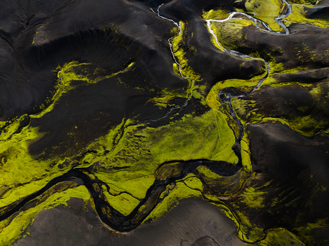 Aerial view of stark dark volcanic sands interwoven with vibrant green moss and glacial streams creating an otherworldly tapestry of textures and tones Iceland. Aerial view of stark dark volcanic sands interwoven with vibrant green moss and glacial streams creating an otherworldly tapestry of textures and tones Iceland.
