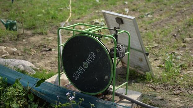 View of a solar powered water pump in a field Nepal.
