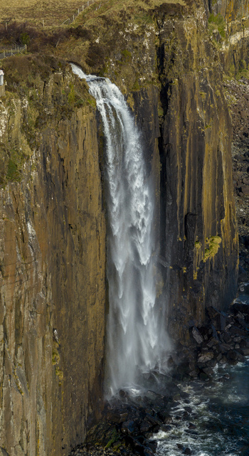 Aerial view of Mealt Falls plunging from the basalt cliffs of Kilt Rock into the sea on the Isle of Skye Scotland United Kingdom. Aerial view of Mealt Falls plunging from the basalt cliffs of Kilt Rock into the sea on the Isle of Skye Scotland United Kingdom.