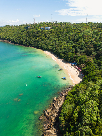 Aerial view of Jungle Beach with turquoise water sandy shore boats and lush green forest in Unawatuna Sri Lanka. Aerial view of Jungle Beach with turquoise water sandy shore boats and lush green forest in Unawatuna Sri Lanka.