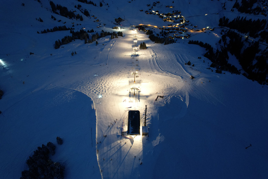 Aerial view of the illuminated ski lifts and snow covered slopes of Les Crosets at night in Val d Illiez Valais Switzerland. Aerial view of the illuminated ski lifts and snow covered slopes of Les Crosets at night in Val d Illiez Valais Switzerland.