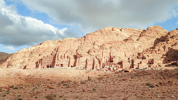 View of the ancient rock cut facades of the Street of Facades in Petra carved into sandstone cliffs under a cloudy sky in Wadi Musa Ma an Governorate Jordan. View of the ancient rock cut facades of the Street of Facades in Petra carved into sandstone cliffs under a cloudy sky in Wadi Musa Ma an Governorate Jordan.