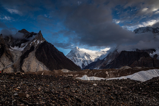 View of the majestic K2 mountain peak rising above the rugged rocky terrain and glaciers of the Karakoram range in Concordia K2 Base Gilgit Baltistan Pakistan. View of the majestic K2 mountain peak rising above the rugged rocky terrain and glaciers of the Karakoram range in Concordia K2 Base Gilgit Baltistan Pakistan.