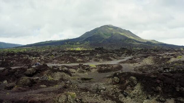 Aerial view of Batur volcano and dark lava fields Indonesia.