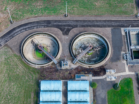 Aerial view of the wastewater treatment plant featuring circular clarifiers and industrial infrastructure in Woodburn Oregon United States. Aerial view of the wastewater treatment plant featuring circular clarifiers and industrial infrastructure in Woodburn Oregon United States.