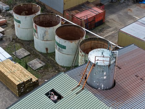 Melbourne VIC Australia 25 September 2026 Aerial view of industrial storage tanks and stacks of lumber at a factory site.