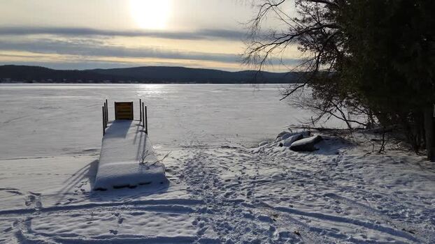Aerial view of a snow covered dock on a frozen lake United States.