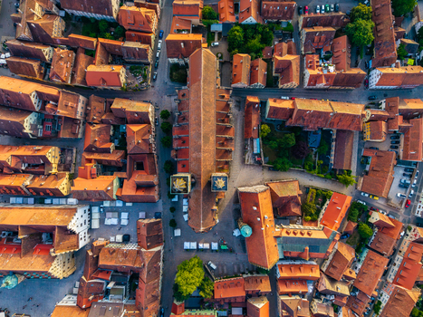 Aerial view of St. Jakob s Church surrounded by historic medieval rooftops narrow streets and stone buildings in Rothenburg ob der Tauber Bavaria Germany. Aerial view of St. Jakob s Church surrounded by historic medieval rooftops narrow streets and stone buildings in Rothenburg ob der Tauber Bavaria Germany.