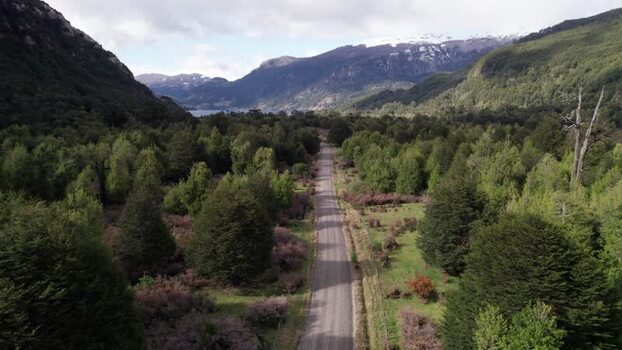 Aerial view of a road through a forest in Coyhaique Chile.