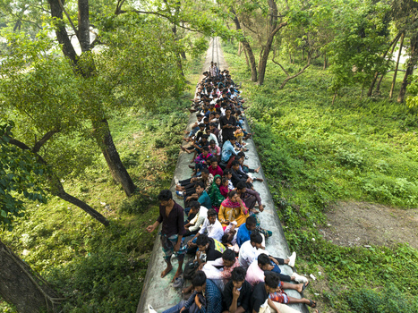 Dhaka Bangladesh 27 March 2026 Aerial view of a crowded train track cutting through lush greenery a vibrant scene of human activity against nature s serene backdrop. Dhaka Bangladesh 27 March 2026 Aerial view of a crowded train track cutting through lush greenery a vibrant scene of human activity against nature s serene backdrop.