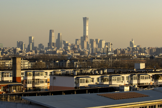 View of the China Zun tower and the central business district skyline behind residential apartment buildings at sunset Beijing Beijing China. View of the China Zun tower and the central business district skyline behind residential apartment buildings at sunset Beijing Beijing China.