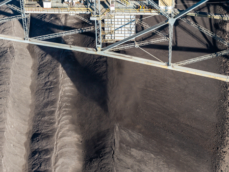 Aerial view of the Tagebau Welzow Sud brown coal open pit mine with its massive industrial excavator structure casting shadows over the dark excavated earth in Spremberg Brandenburg Germany. Aerial view of the Tagebau Welzow Sud brown coal open pit mine with its massive industrial excavator structure casting shadows over the dark excavated earth in Spremberg Brandenburg Germany.