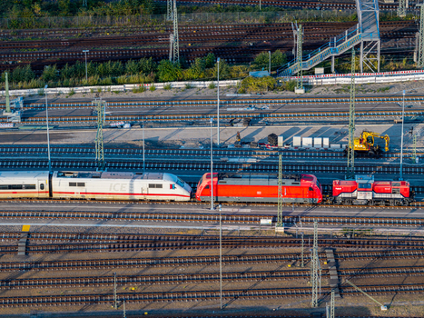 Berlin Germany 20 September 2026 Aerial view of ICE Werk Berlin Rummelsburg featuring an ICE high speed train and a red locomotive on the railway tracks. Berlin Germany 20 September 2026 Aerial view of ICE Werk Berlin Rummelsburg featuring an ICE high speed train and a red locomotive on the railway tracks.