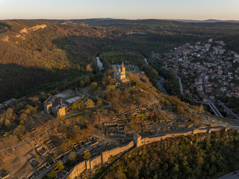 Aerial view of Tsarevets Fortress a historic medieval stronghold with stone walls and a central church on a hill overlooking the Yantra River in Veliko Tarnovo Veliko Tarnovo Bulgaria. Aerial view of Tsarevets Fortress a historic medieval stronghold with stone walls and a central church on a hill overlooking the Yantra River in Veliko Tarnovo Veliko Tarnovo Bulgaria.