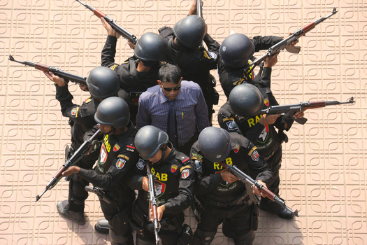 Dhaka Bangladesh 06 January 2017 View of Rapid Action Battalion RAB officers in black uniforms and helmets holding rifles during a drill at the RAB Headquarters. Dhaka Bangladesh 06 January 2017 View of Rapid Action Battalion RAB officers in black uniforms and helmets holding rifles during a drill at the RAB Headquarters.