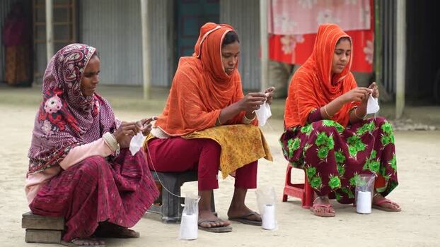 View of women hand stitching in a rural setting Bangladesh. View of women hand stitching in a rural setting Bangladesh.