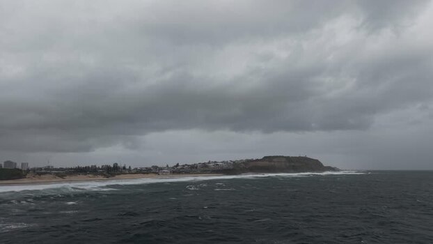 Aerial view of coastline with dark clouds Australia.