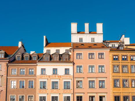 View of the colorful historic facades and ornate architectural details of the buildings in Warsaw Old Town under a clear blue sky in Warsaw Masovian Voivodeship Poland. View of the colorful historic facades and ornate architectural details of the buildings in Warsaw Old Town under a clear blue sky in Warsaw Masovian Voivodeship Poland.