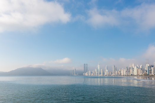 Aerial view of the modern coastal skyline of Balneario Camboriu with skyscrapers partially shrouded in morning fog along the Atlantic shore in Balneario Camboriu State of Santa Catarina Brazil. Aerial view of the modern coastal skyline of Balneario Camboriu with skyscrapers partially shrouded in morning fog along the Atlantic shore in Balneario Camboriu State of Santa Catarina Brazil.