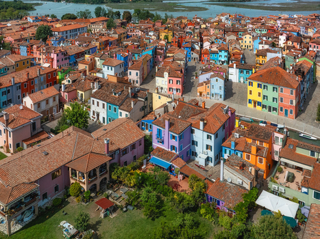 Aerial view of a vibrant tapestry of multicolored houses a kaleidoscope of pastel shades reflecting the bright sunlight creating a picturesque scene Venice Veneto Italy. Aerial view of a vibrant tapestry of multicolored houses a kaleidoscope of pastel shades reflecting the bright sunlight creating a picturesque scene Venice Veneto Italy.