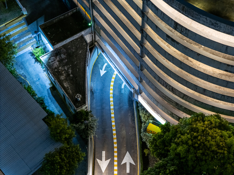 Aerial view of a parking garage ramp at night with illuminated lane markings and directional arrows in Santo Domingo Distrito Nacional Dominican Republic. Aerial view of a parking garage ramp at night with illuminated lane markings and directional arrows in Santo Domingo Distrito Nacional Dominican Republic.