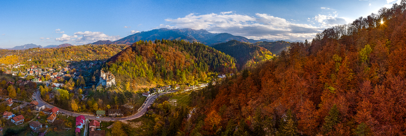 Aerial view of the historic Bran Castle nestled in the vibrant autumn forests of the Carpathian Mountains near the town of Bran Brasov Romania. Aerial view of the historic Bran Castle nestled in the vibrant autumn forests of the Carpathian Mountains near the town of Bran Brasov Romania.