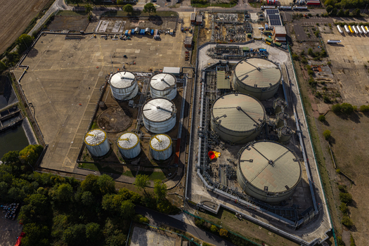 Aerial view of the Hemel Hempstead Industrial Estate featuring large storage tanks industrial pipelines and surrounding green space in Hemel Hempstead England United Kingdom. Aerial view of the Hemel Hempstead Industrial Estate featuring large storage tanks industrial pipelines and surrounding green space in Hemel Hempstead England United Kingdom.