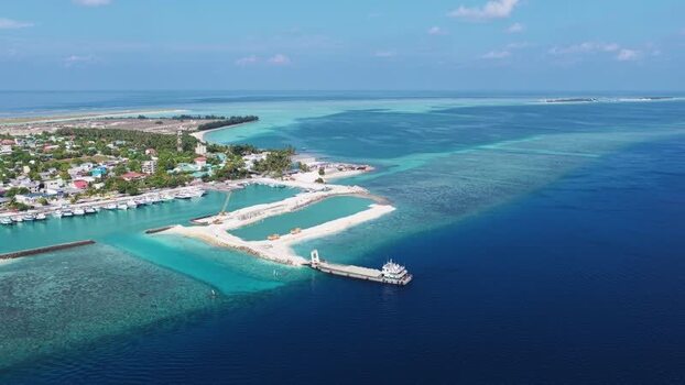 Aerial view of the harbor and coastline of Kudahuvadhoo Maldives. Aerial view of the harbor and coastline of Kudahuvadhoo Maldives.
