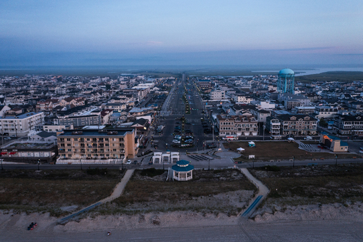 Aerial view of Sea Isle City Beach at dusk featuring the coastal town layout residential buildings a water tower and the main street in Sea Isle City New Jersey United States.