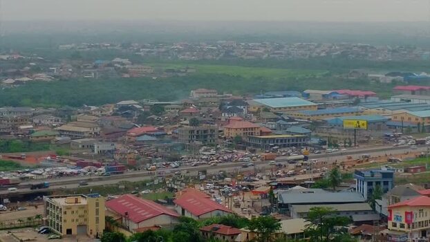 Aerial view of Magboro Bus Stop and highway traffic Nigeria.