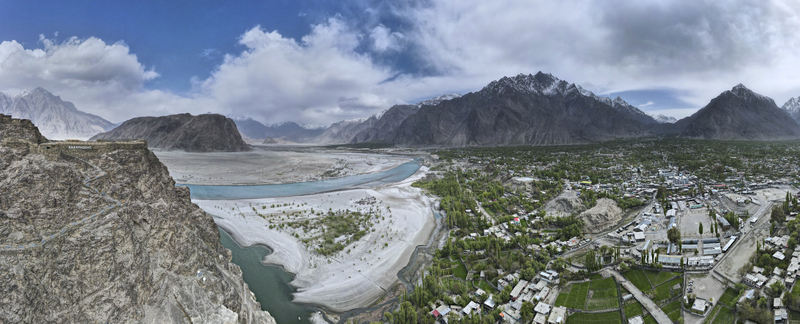 Aerial view of Kharpocho Fort overlooking the Indus River and the town of Skardu with rugged mountains and a cloudy sky in the background Skardu Gilgit Baltistan Pakistan.