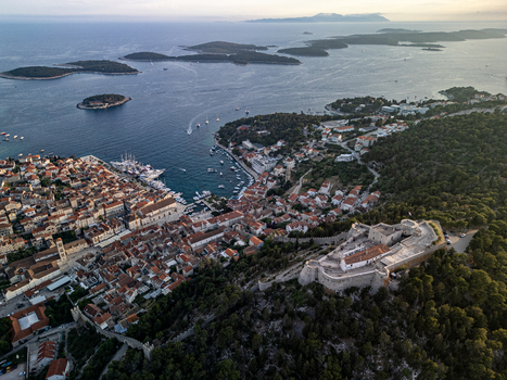 Aerial view of the historic Spanish Fortress overlooking the old town harbor and Pakleni Islands at dusk Hvar Split Dalmatia County Croatia.