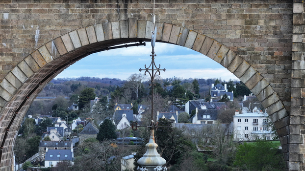 Aerial view of the Eglise Saint Melaine spire and the historic town center framed by a stone viaduct arch Morlaix Bretagne France. Aerial view of the Eglise Saint Melaine spire and the historic town center framed by a stone viaduct arch Morlaix Bretagne France.