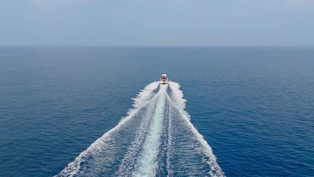 Aerial view of a boat sailing in the ocean Maldives.