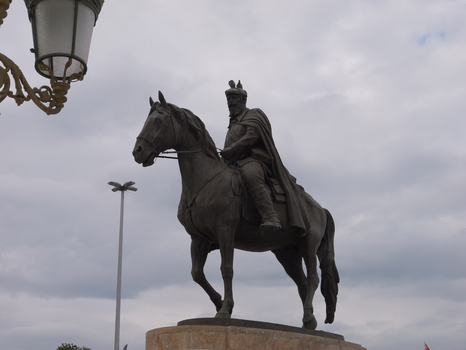View of the bronze equestrian statue of Tsar Samuil standing on a stone pedestal under a cloudy sky in Skopje Greater Skopje North Macedonia.
