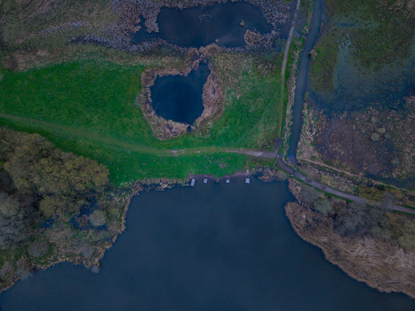 Aerial view of Doxey Marshes featuring wetlands ponds green meadows and winding paths in Stafford England United Kingdom. Aerial view of Doxey Marshes featuring wetlands ponds green meadows and winding paths in Stafford England United Kingdom.