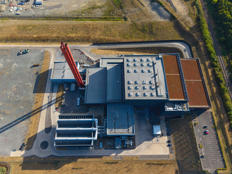 Aerial view of Rookery South ERF with its prominent red chimney and industrial facility buildings surrounded by paved areas and green landscape in Stewartby England United Kingdom. Aerial view of Rookery South ERF with its prominent red chimney and industrial facility buildings surrounded by paved areas and green landscape in Stewartby England United Kingdom.
