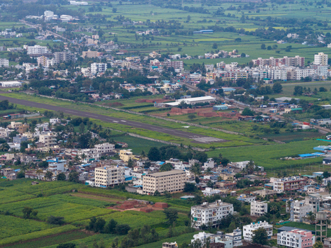Aerial view of the airstrip and surrounding urban landscape with green agricultural fields in Karad Maharashtra India.